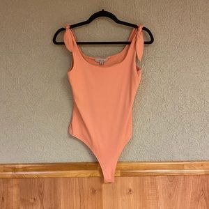 Tie straps body suit. Never worn